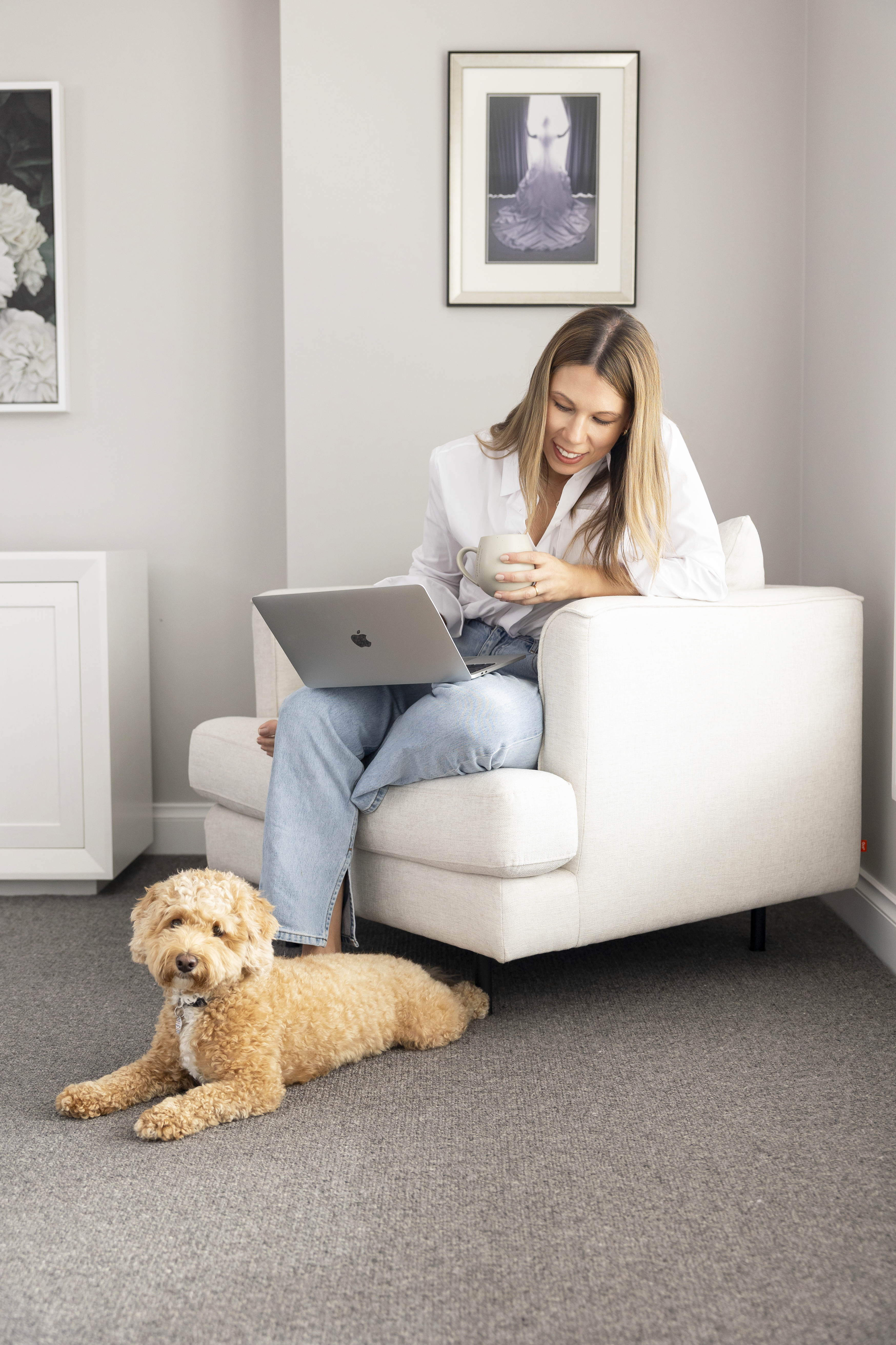 Woman relaxing with laptop and dog
